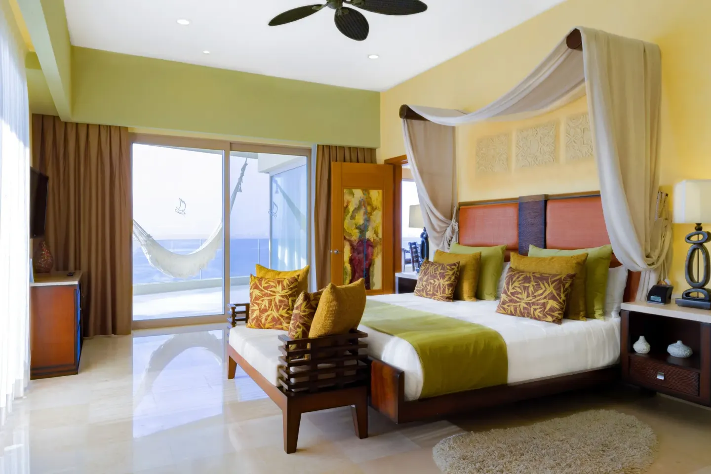 One Bedroom Suite king bed and balcony hammock at Garza Blanca Preserve Resort & Spa.