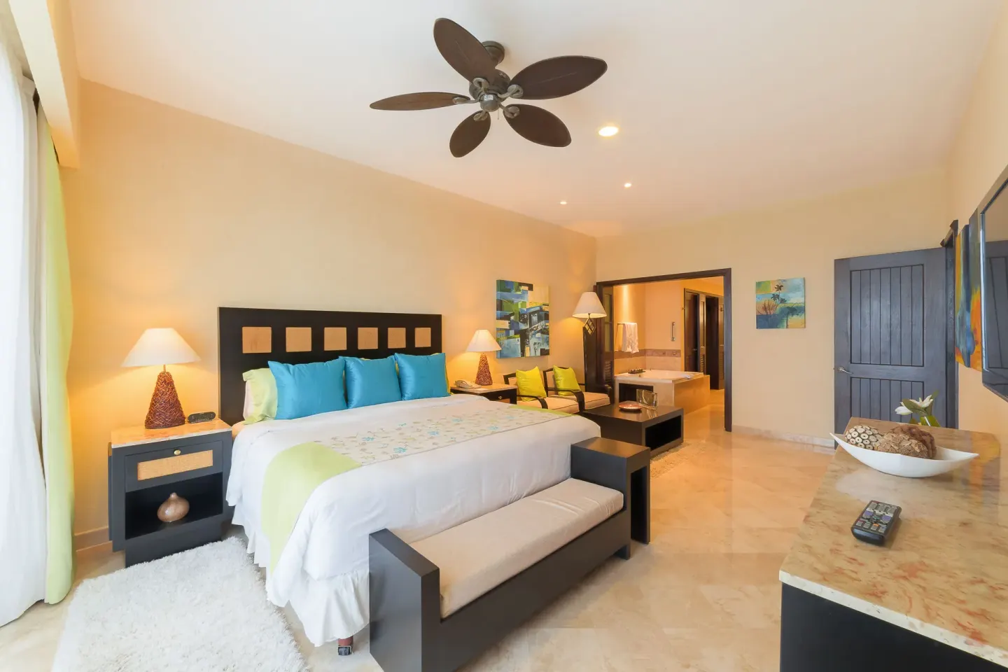 One Bedroom Suite bedroom with king bed and bath at Garza Blanca Preserve Resort & Spa.