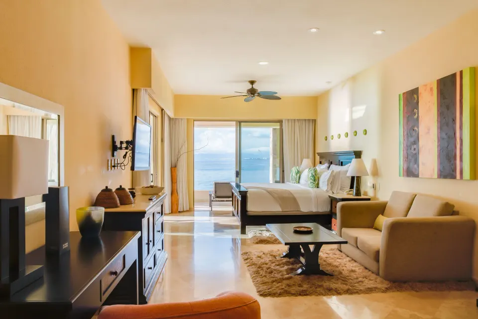 Honeymoon Suite living area with king bed and ocean view at Garza Blanca Preserve Resort & Spa.