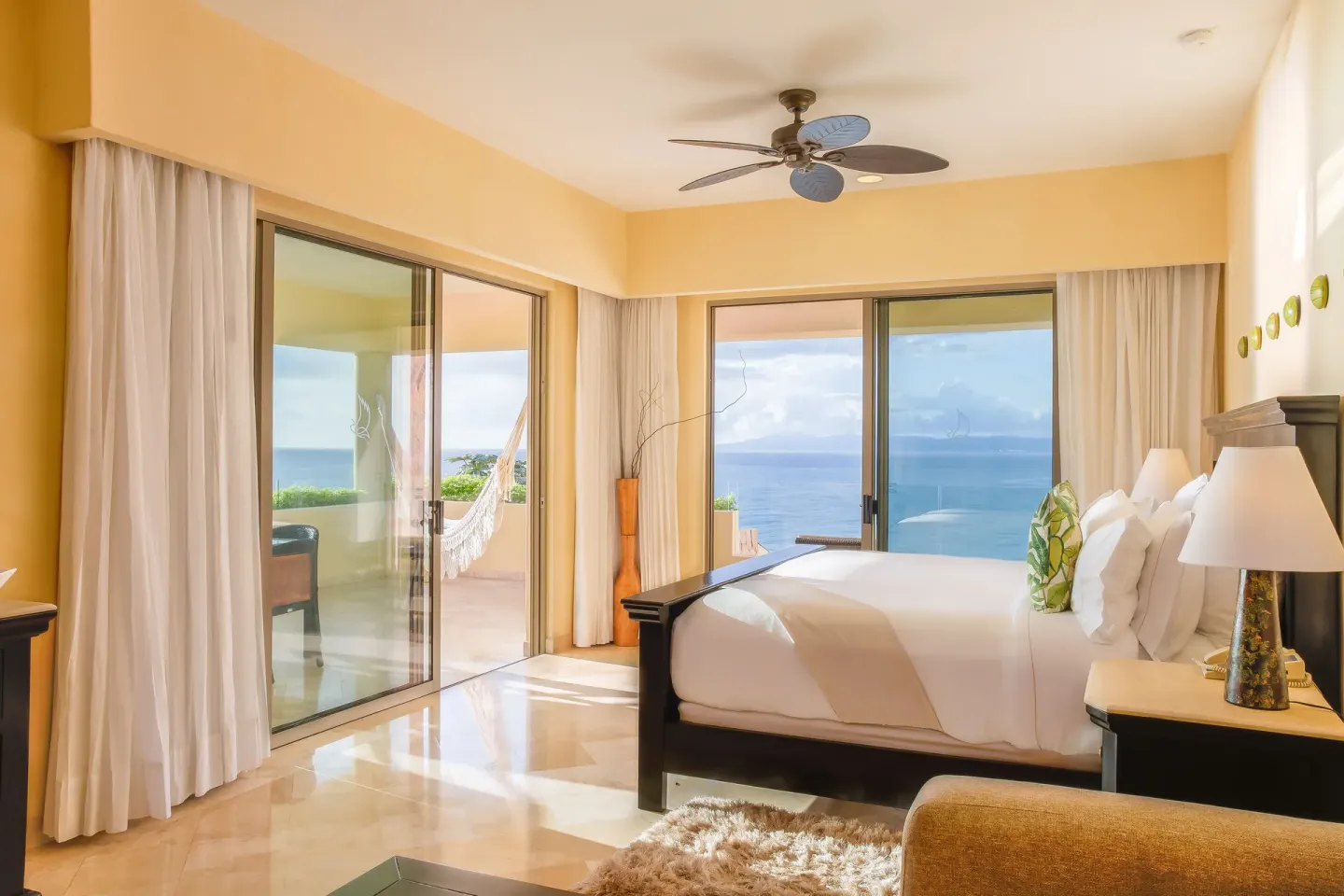 Honeymoon Suite king bed and ocean-view balcony at Garza Blanca Preserve Resort & Spa.
