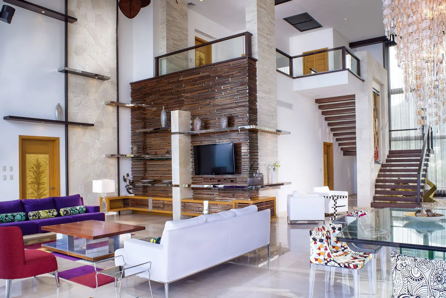 Grand Penthouse living room with staircase at Garza Blanca Preserve Resort & Spa.