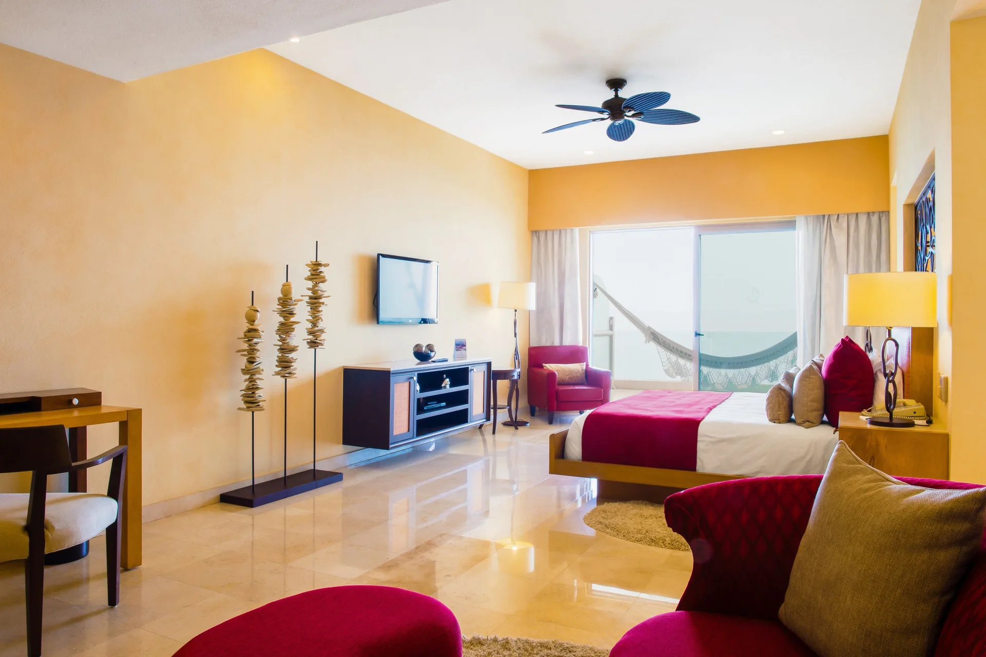 Two Bedroom Panoramic Suite bedroom with king bed and balcony hammock at Garza Blanca Preserve Resort & Spa.