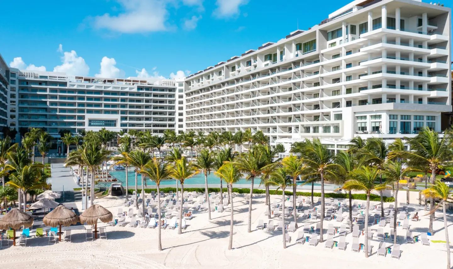 The beachfront, pools, palms, and resort buildings at Garza Blanca Resort & Spa Cancun.