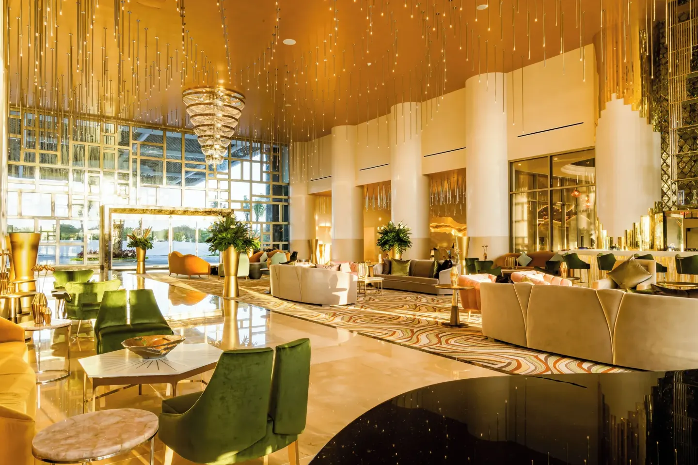 Grand lobby lounge with gold ceiling and seating at Garza Blanca Resort & Spa Cancun.