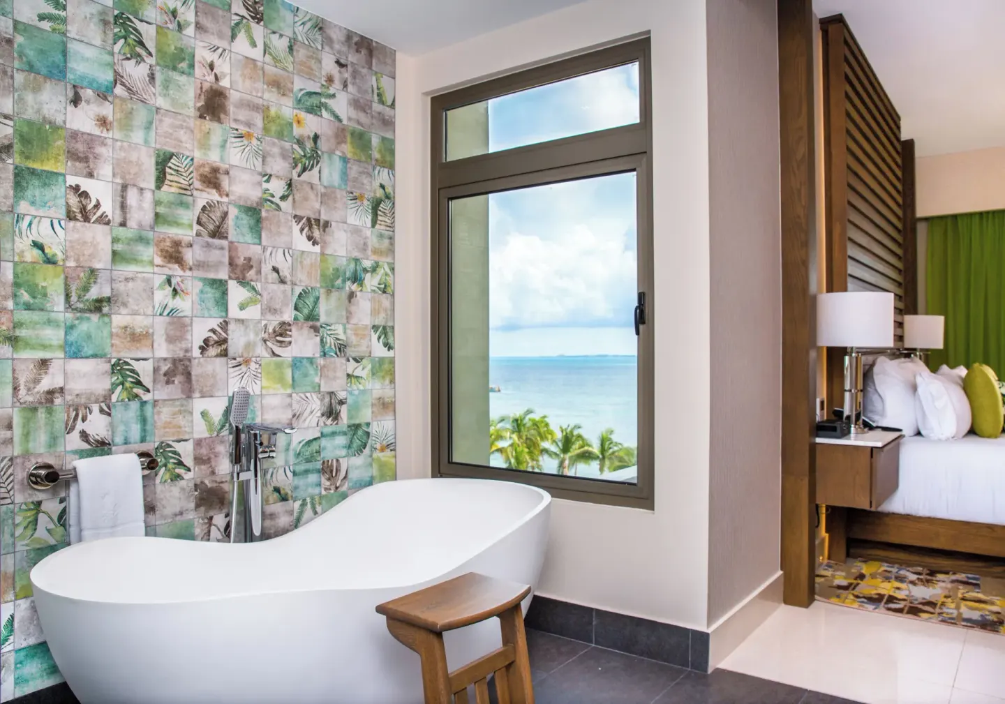 Freestanding bathtub beside an ocean-view window at Garza Blanca Resort & Spa Cancun.