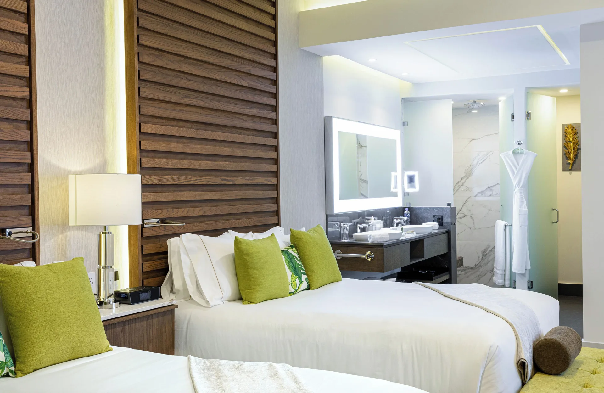 Double bed guest room with open vanity and shower at Garza Blanca Resort & Spa Cancun.