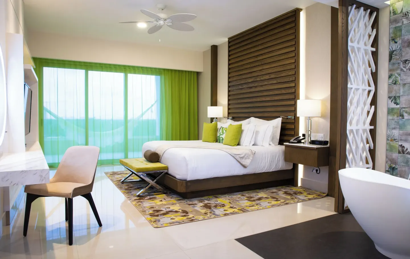 Guest room with king bed and freestanding tub at Garza Blanca Resort & Spa Cancun.