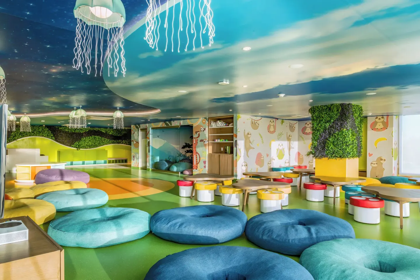Kids club lounge with round cushions and animal murals at Garza Blanca Resort & Spa Cancun.