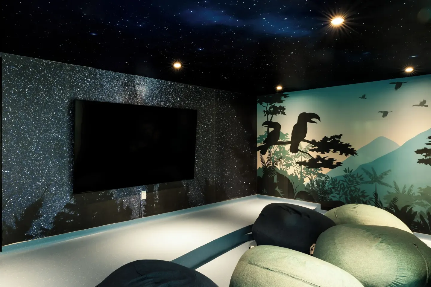 Kids media room with beanbags and jungle mural at Garza Blanca Resort & Spa Cancun.