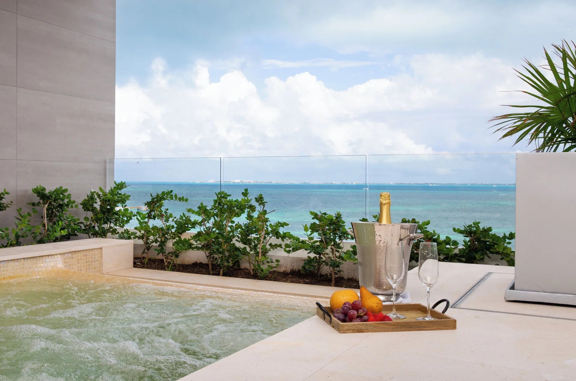 Private terrace plunge pool with sparkling wine and ocean view at Garza Blanca Resort & Spa Cancun.