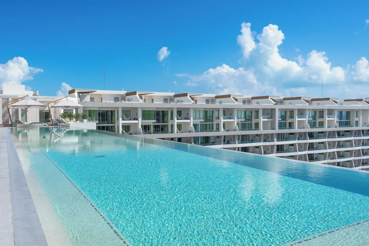 Rooftop infinity pool and guest balconies at Garza Blanca Resort & Spa Cancun.