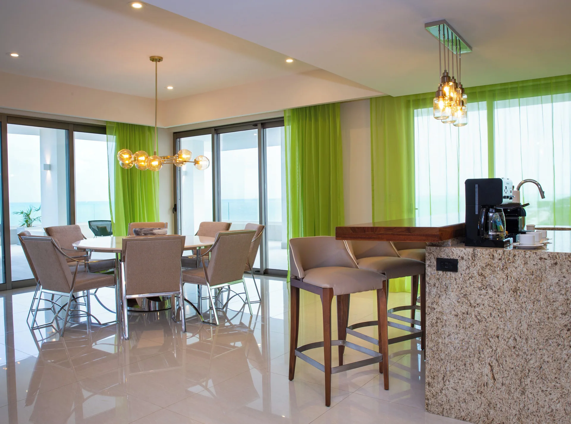 Suite dining area and breakfast bar with ocean visible at Garza Blanca Resort & Spa Cancun.