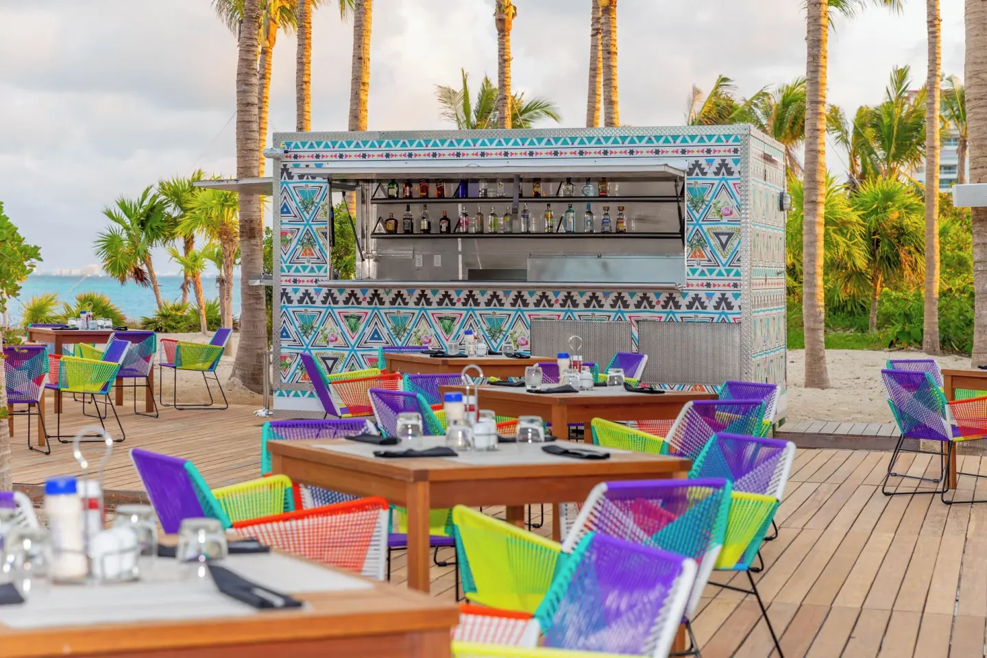 Colorful outdoor poolside bar and seating at Garza Blanca Resort & Spa Cancun.