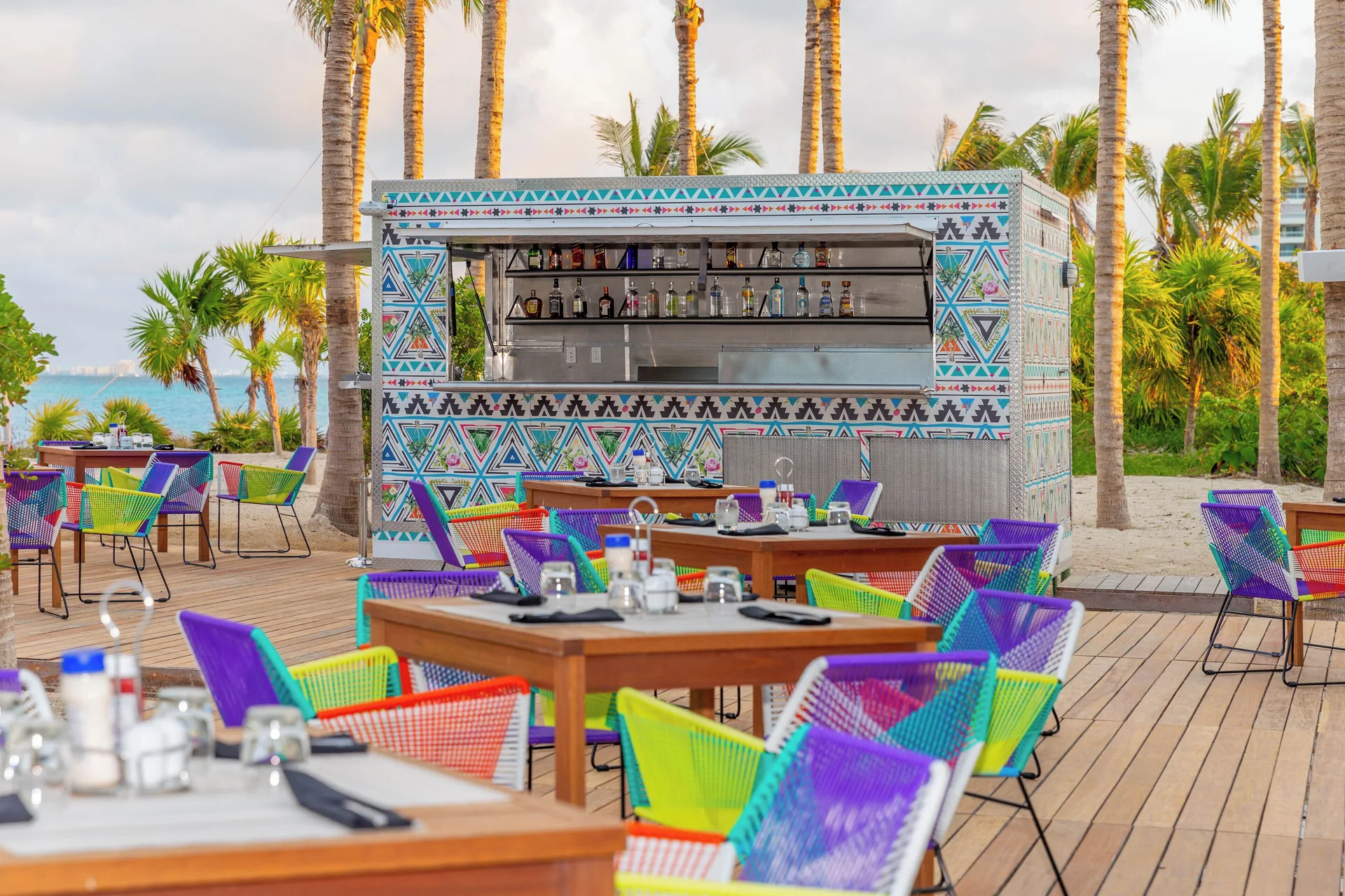 Colorful outdoor poolside bar and seating at Garza Blanca Resort & Spa Cancun.