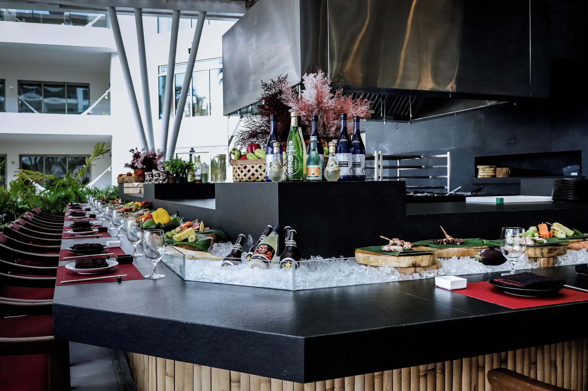Japanese dining counter with chilled bottles and seafood at Garza Blanca Resort & Spa Cancun.
