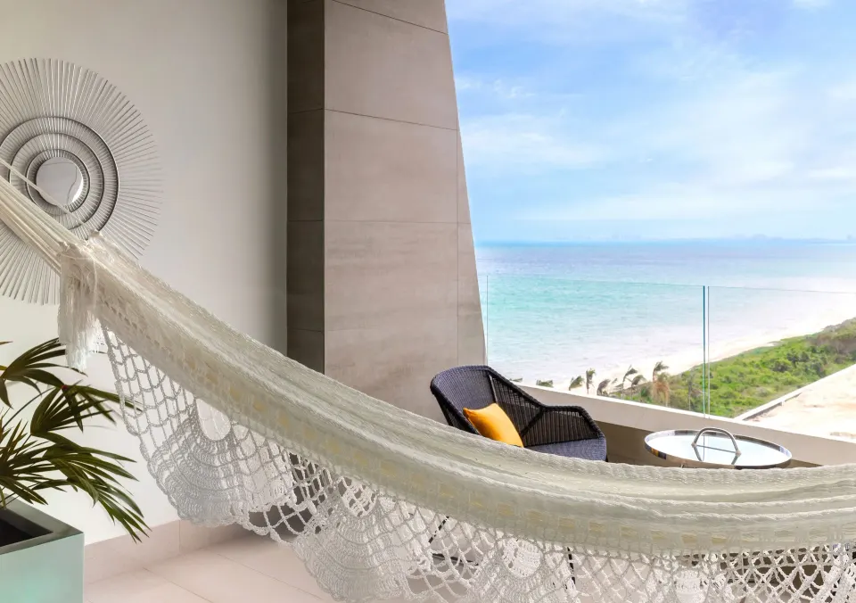 Junior Suite Ocean View balcony hammock overlooking the sea at Garza Blanca Resort & Spa Cancun.
