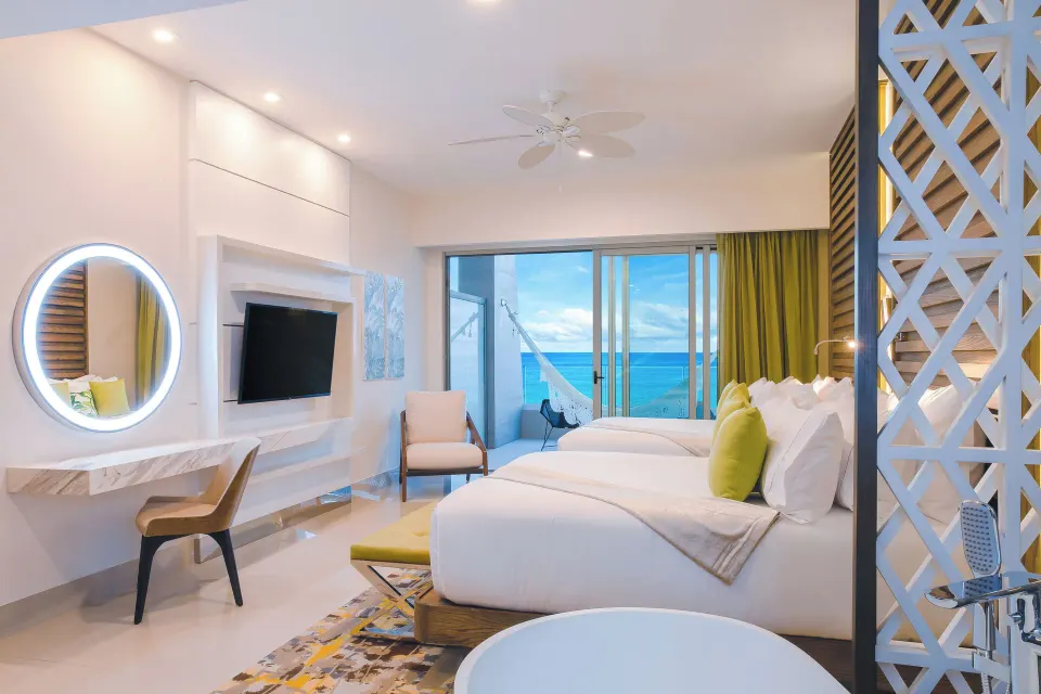 Junior Suite Ocean View with two beds and ocean-facing balcony at Garza Blanca Resort & Spa Cancun.