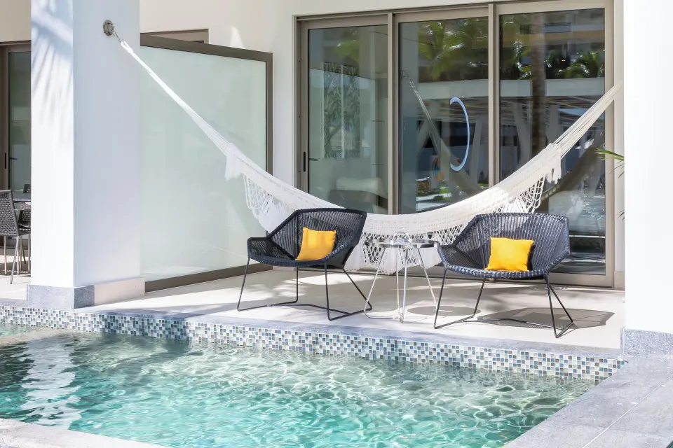 Junior Suite Swim Up patio with hammock and pool at Garza Blanca Resort & Spa Cancun.