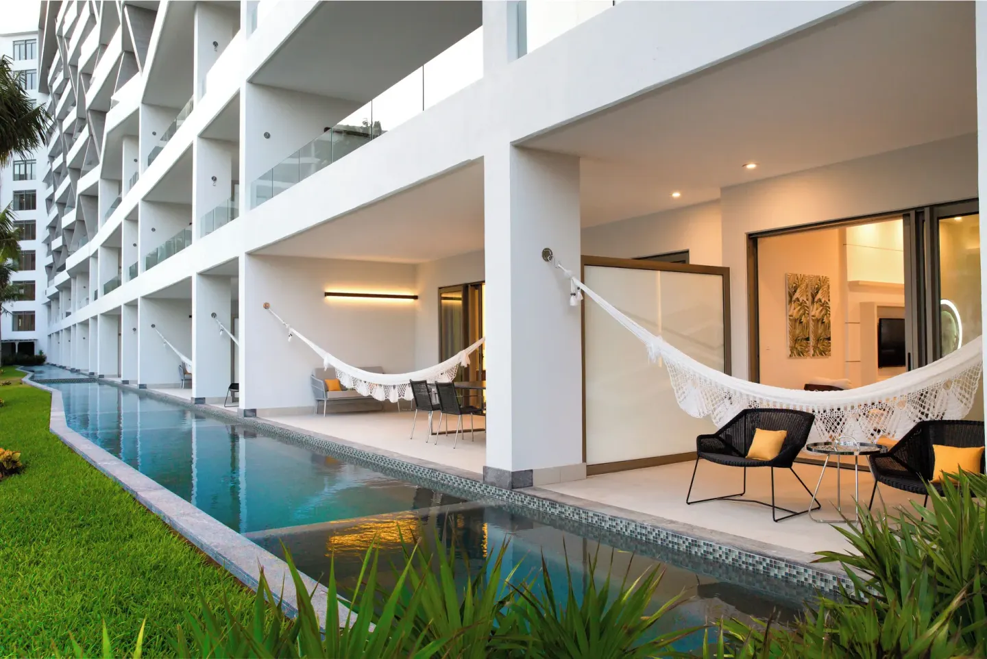 Row of Junior Suite Swim Up terraces beside the pool at Garza Blanca Resort & Spa Cancun.