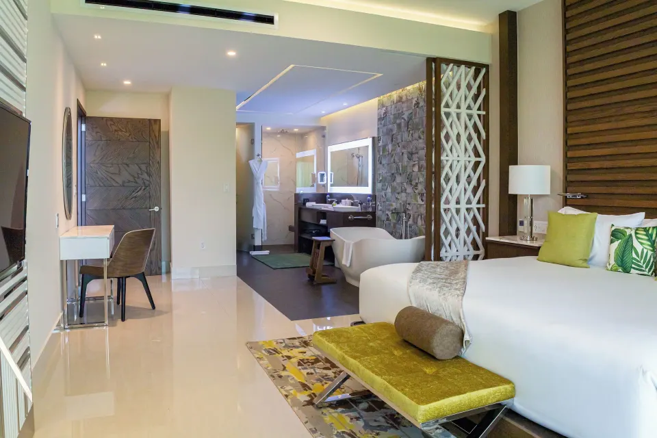 Junior Suite king bed with freestanding tub at Garza Blanca Resort & Spa Cancun.