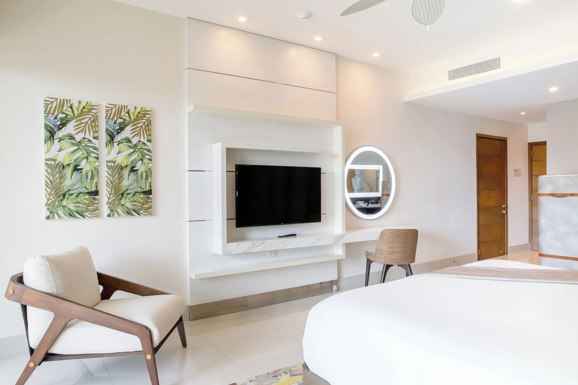 Junior Suite media wall and bed at Garza Blanca Resort & Spa Cancun.