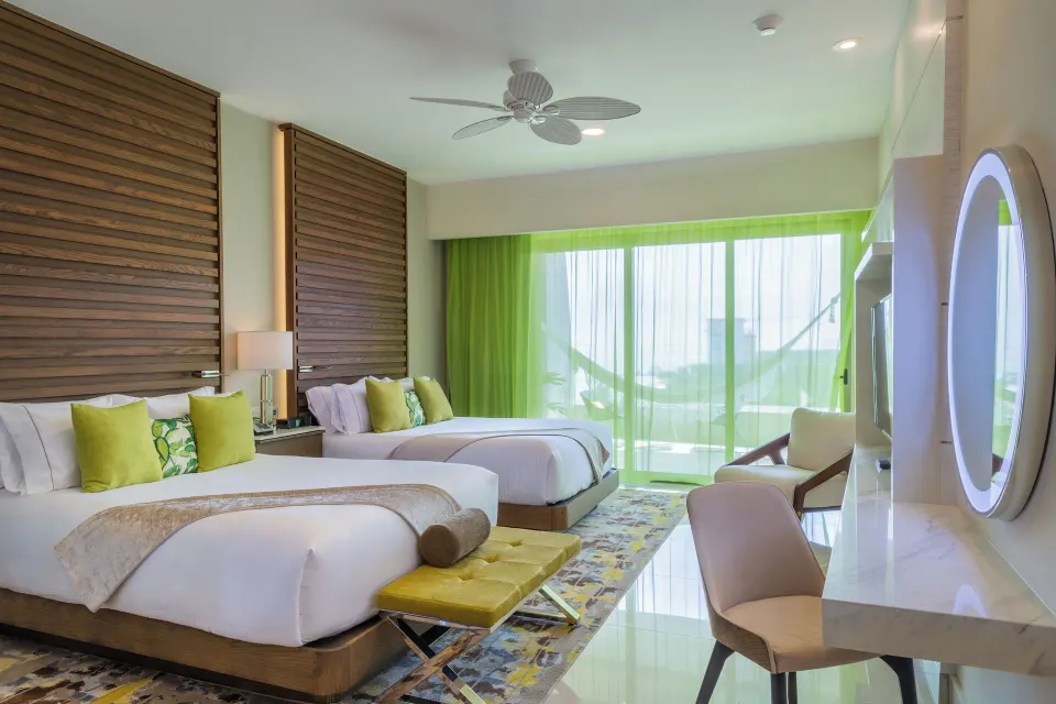 Junior Suite two beds with balcony doors at Garza Blanca Resort & Spa Cancun.