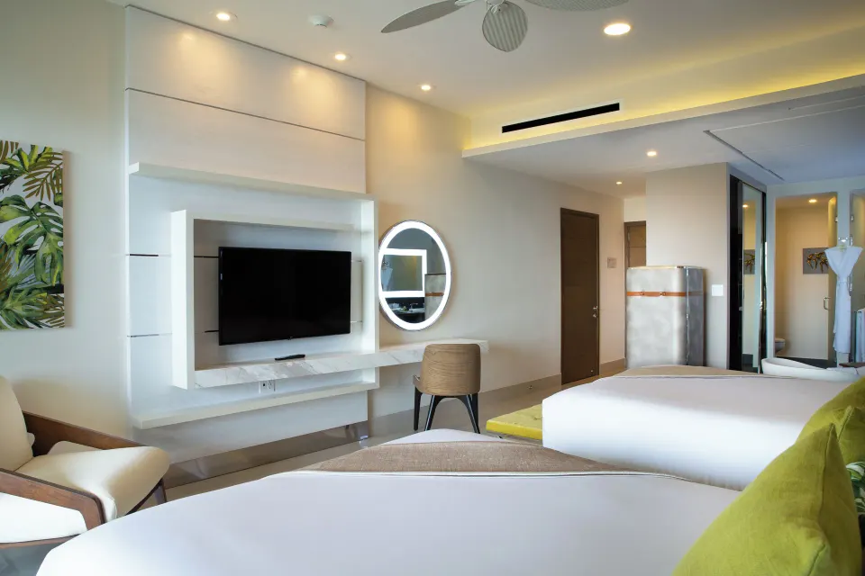 Junior Suite with two beds and vanity area at Garza Blanca Resort & Spa Cancun.