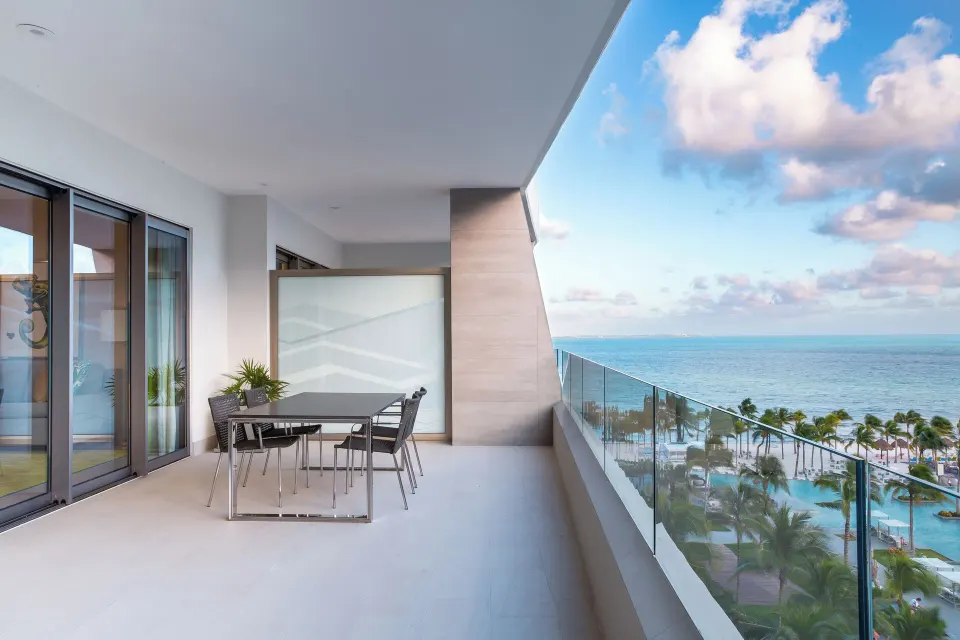 One Bedroom Ocean View balcony with dining table at Garza Blanca Resort & Spa Cancun.