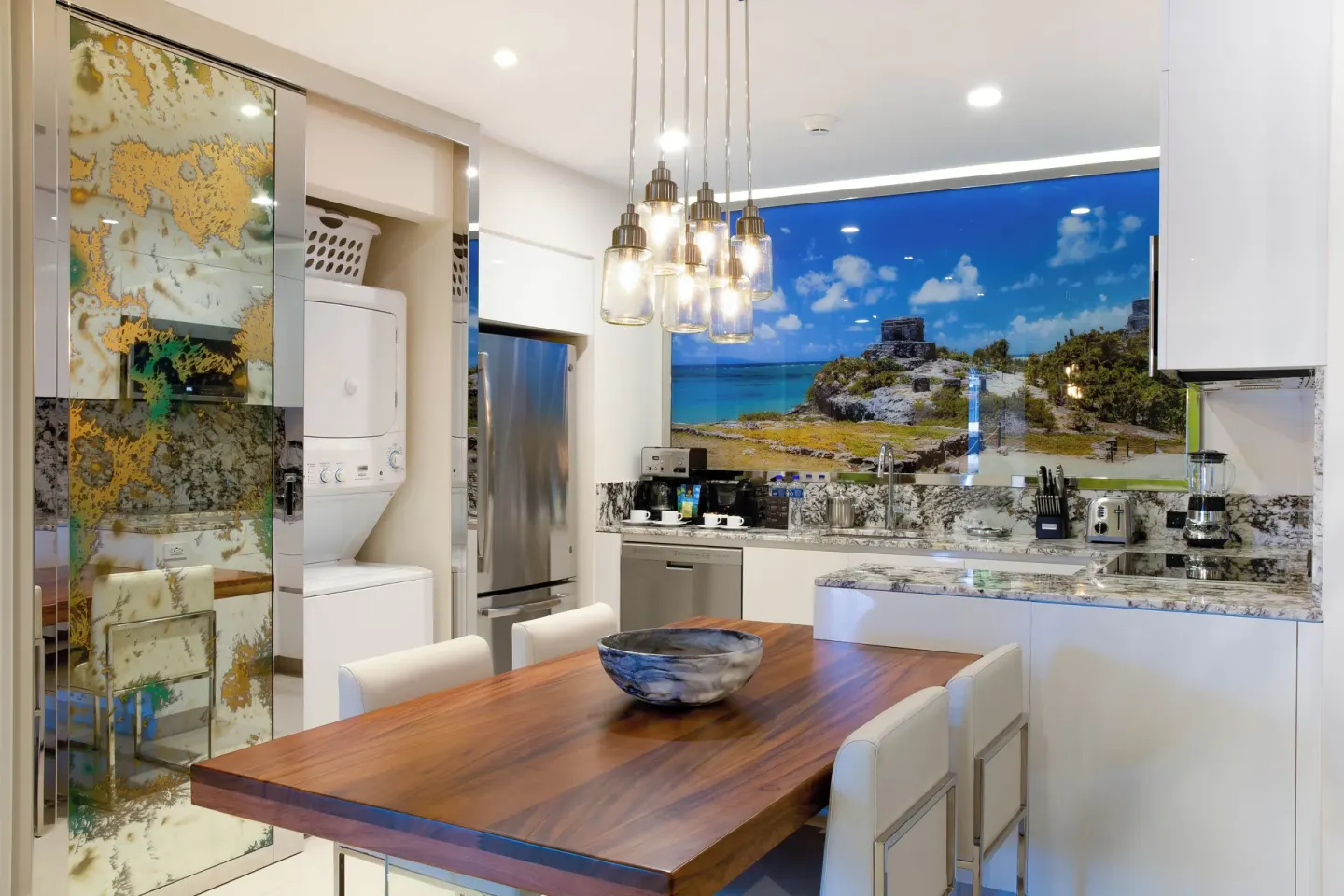 One Bedroom Ocean View kitchen and dining area at Garza Blanca Resort & Spa Cancun.