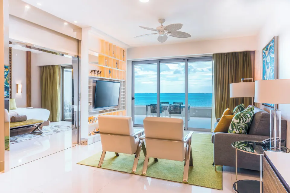 One Bedroom Ocean View living room and balcony at Garza Blanca Resort & Spa Cancun.