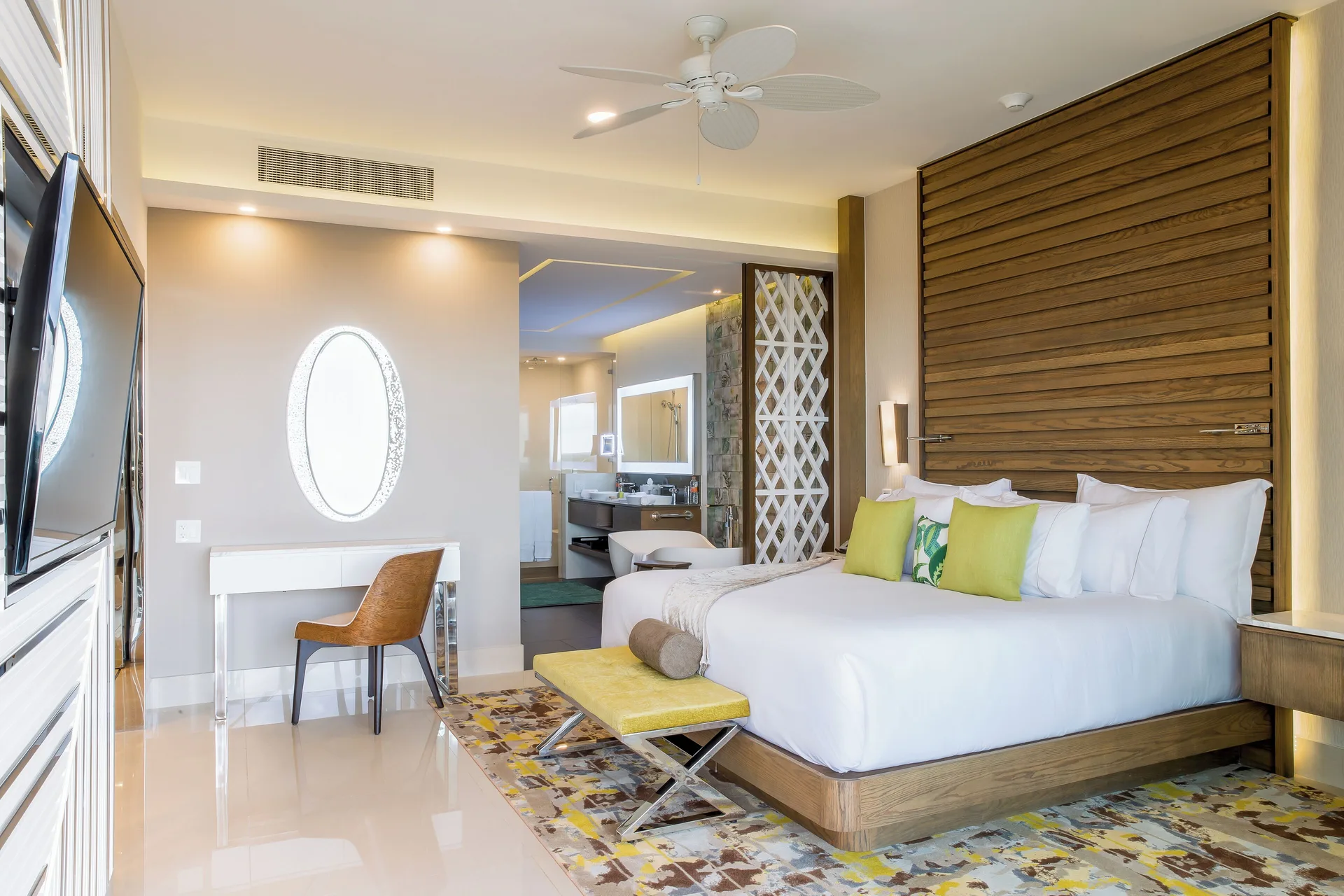 One Bedroom Suite king bed and vanity at Garza Blanca Resort & Spa Cancun.