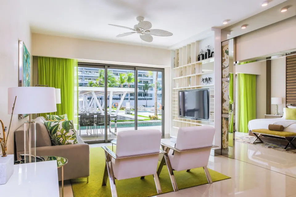 One Bedroom Swim Up living room and king bed at Garza Blanca Resort & Spa Cancun.