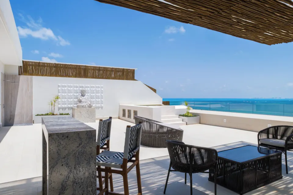 Rooftop terrace seating and ocean view at the Three Bedroom Loft at Garza Blanca Resort & Spa Cancun.