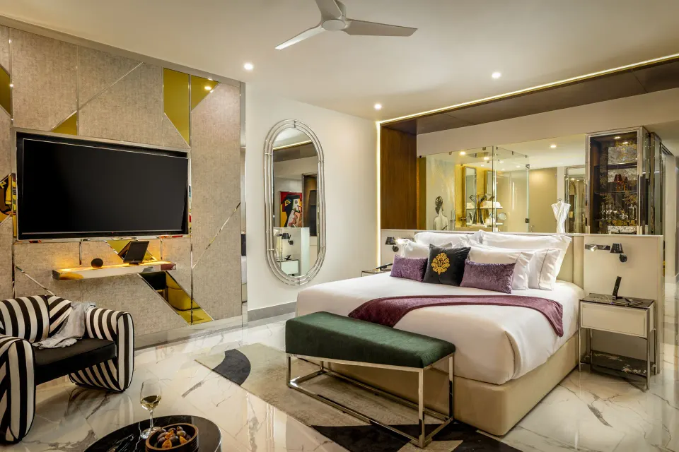 King bed guest room with glass bath area at Garza Blanca Resort & Spa Cancun.