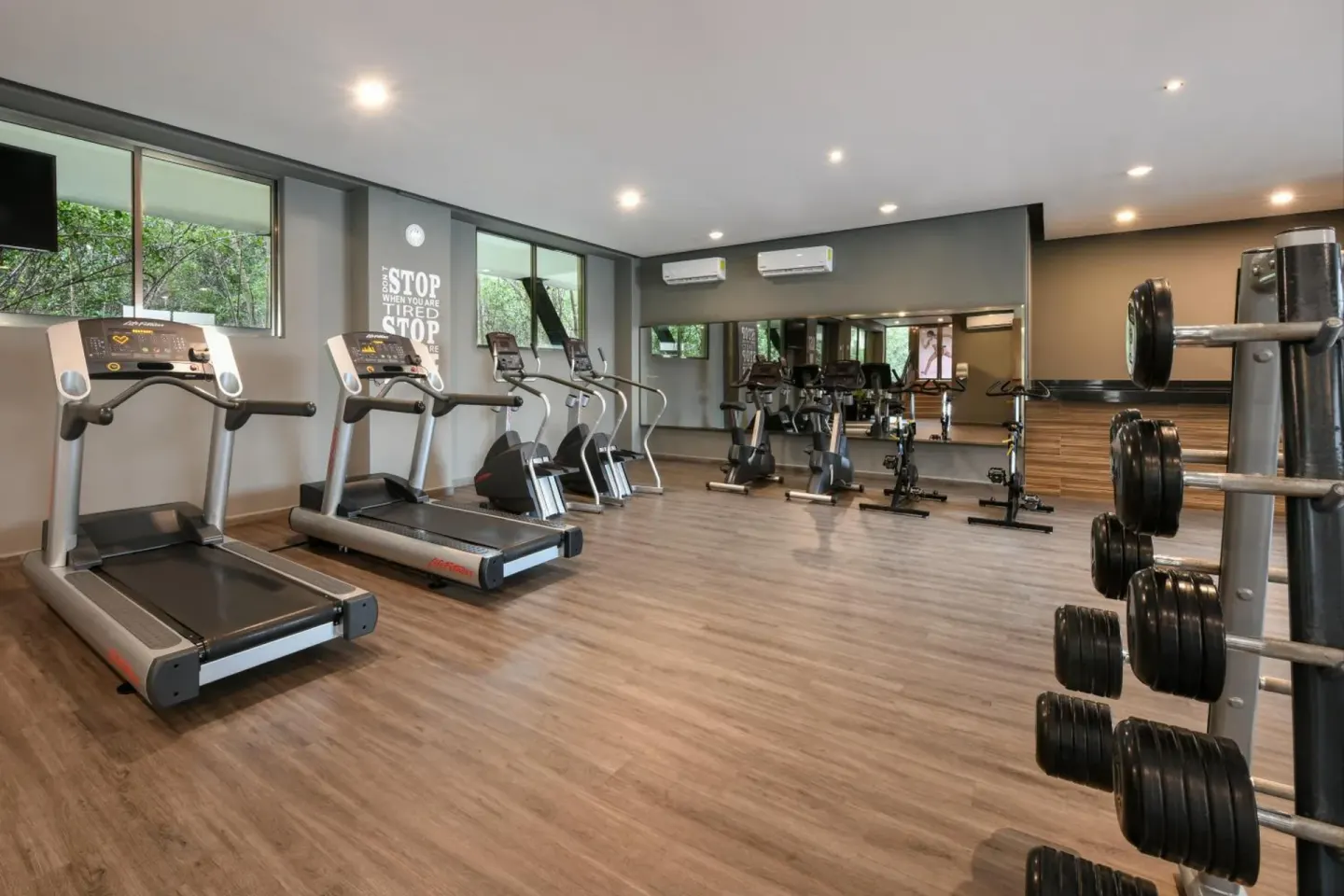 Fitness center with treadmills, bikes, and weights at Generations Riviera Maya.