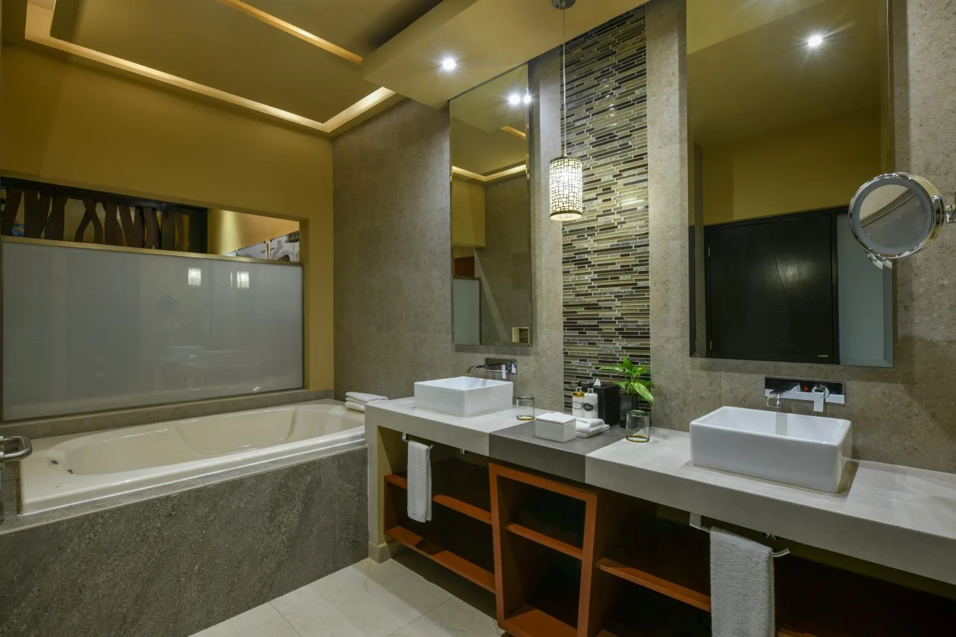 Bathroom with double vessel sinks, large mirrors, and a soaking tub at Generations Riviera Maya.