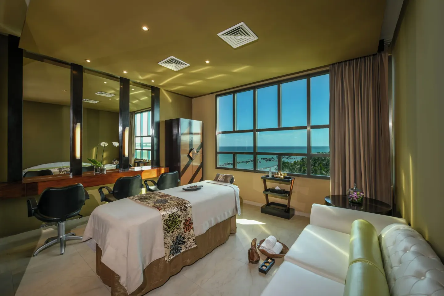 Spa treatment room with ocean-facing windows at Generations Riviera Maya.