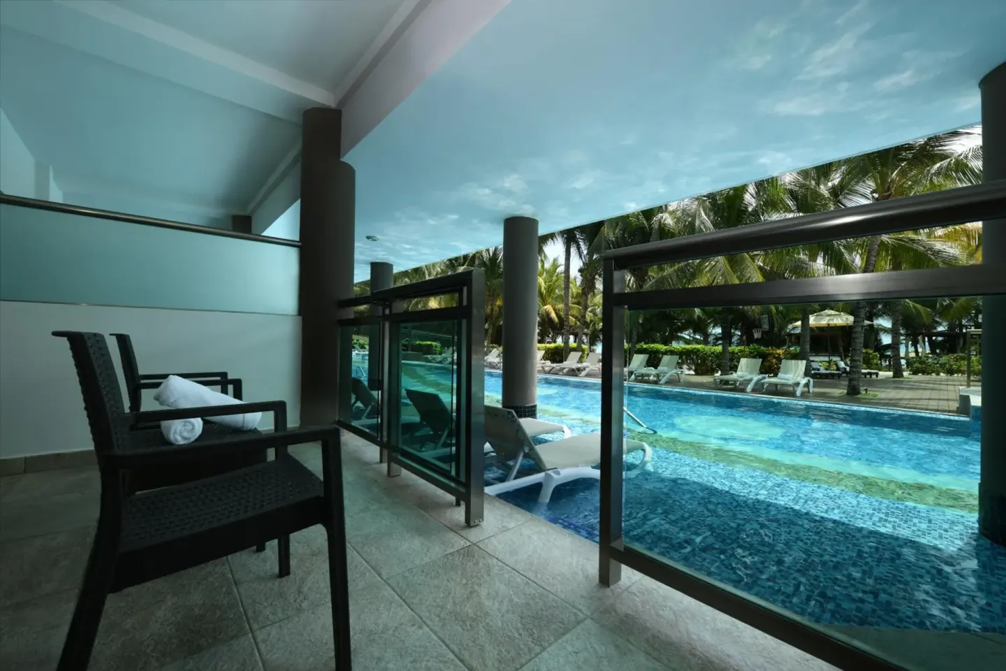 Covered terrace beside a swim-up pool at Generations Riviera Maya.