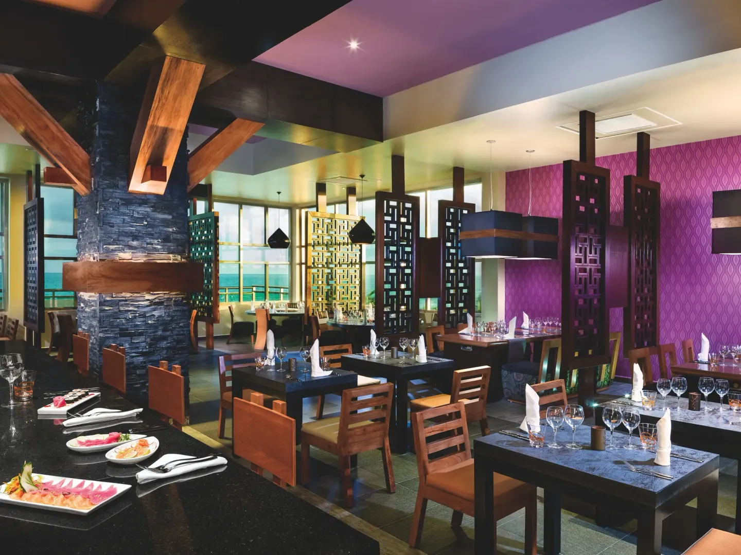 Pan-Asian style dining room with dark tables at Generations Riviera Maya.
