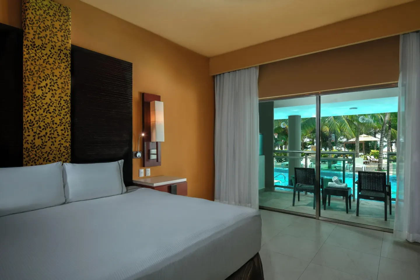 Oceanfront Pool Swim Up Suite king bed and balcony at Generations Riviera Maya.