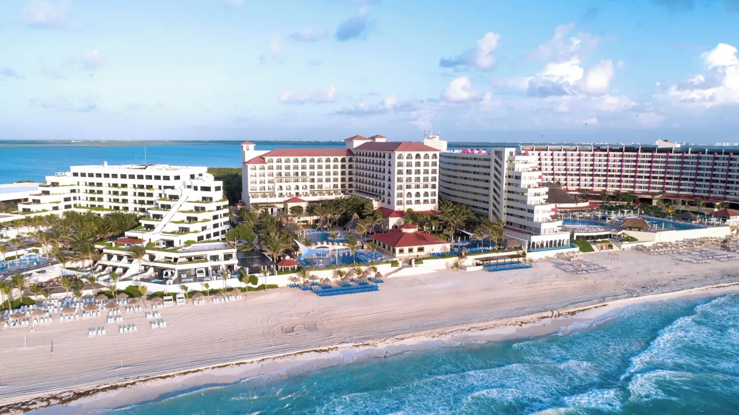 Aerial view of the beachfront resort buildings and pools at GR Solaris Cancun & Spa.