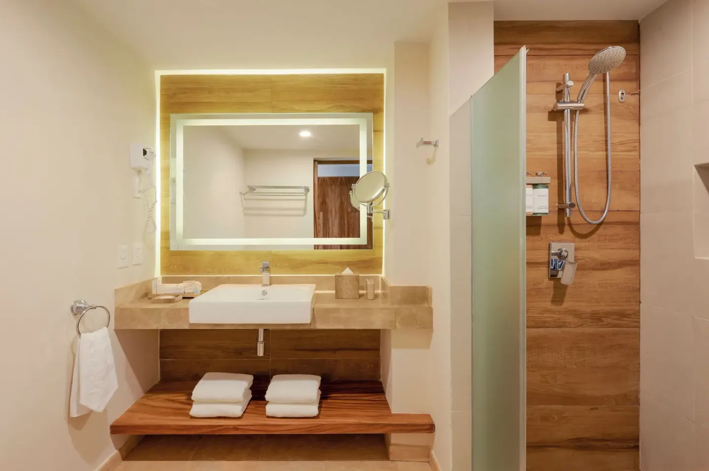 Guest room bathroom with lit mirror and walk-in shower at GR Solaris Cancun & Spa.