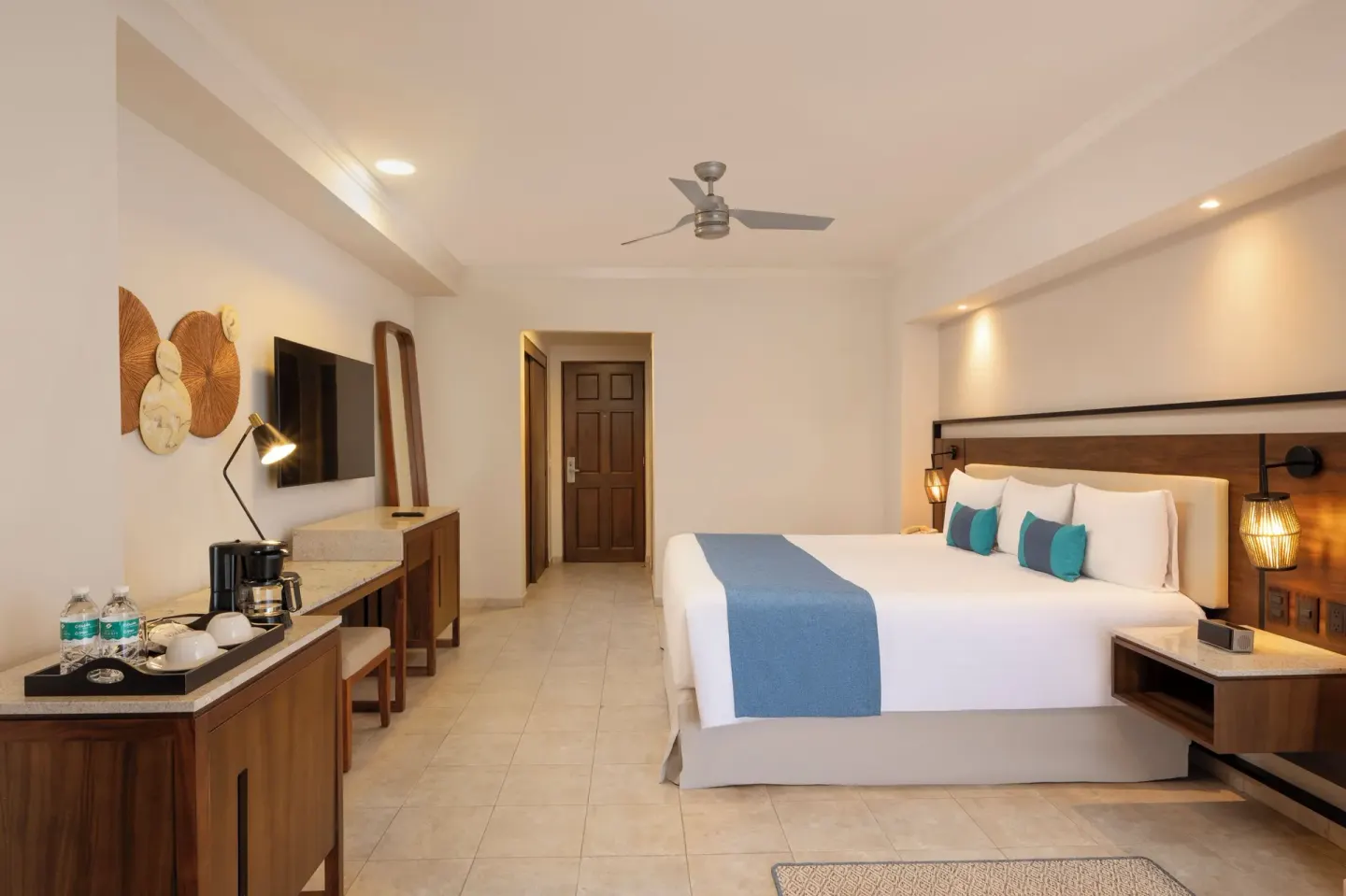King guest room with beverage station and wall-mounted TV at GR Solaris Cancun & Spa.