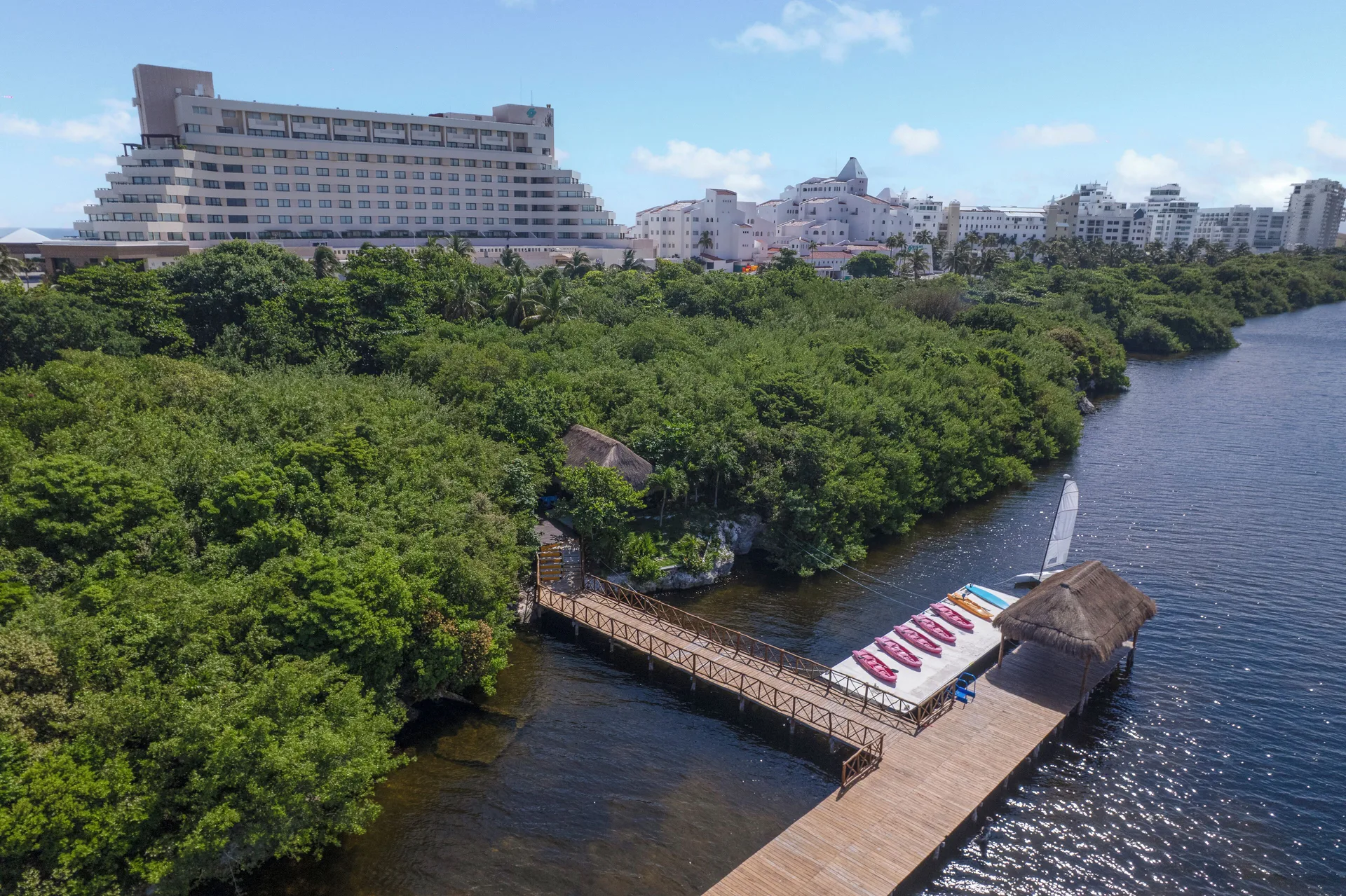 Lagoonfront dock and resort buildings at GR Solaris Cancun & Spa.