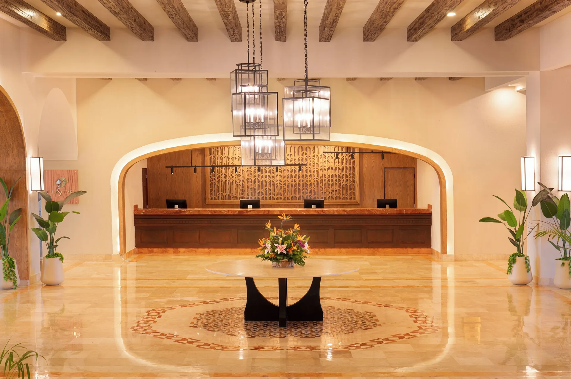 Reception desk and polished lobby with hanging lanterns at GR Solaris Cancun & Spa.