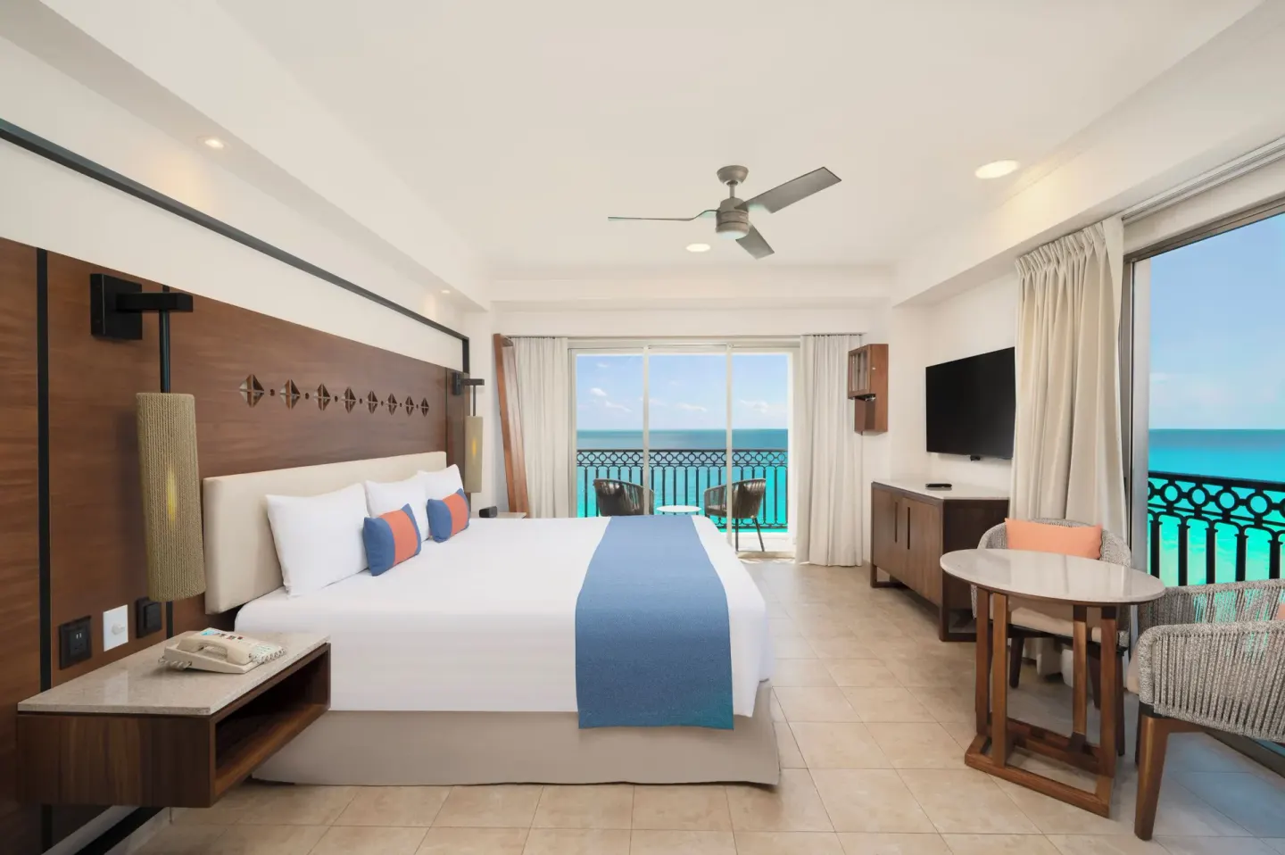King guest room with ocean-facing windows and balcony at GR Solaris Cancun & Spa.