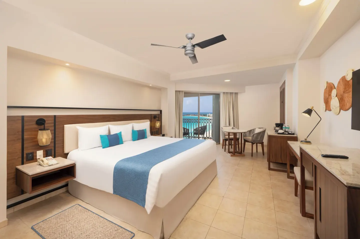 King guest room with desk, seating area, and ocean balcony at GR Solaris Cancun & Spa.
