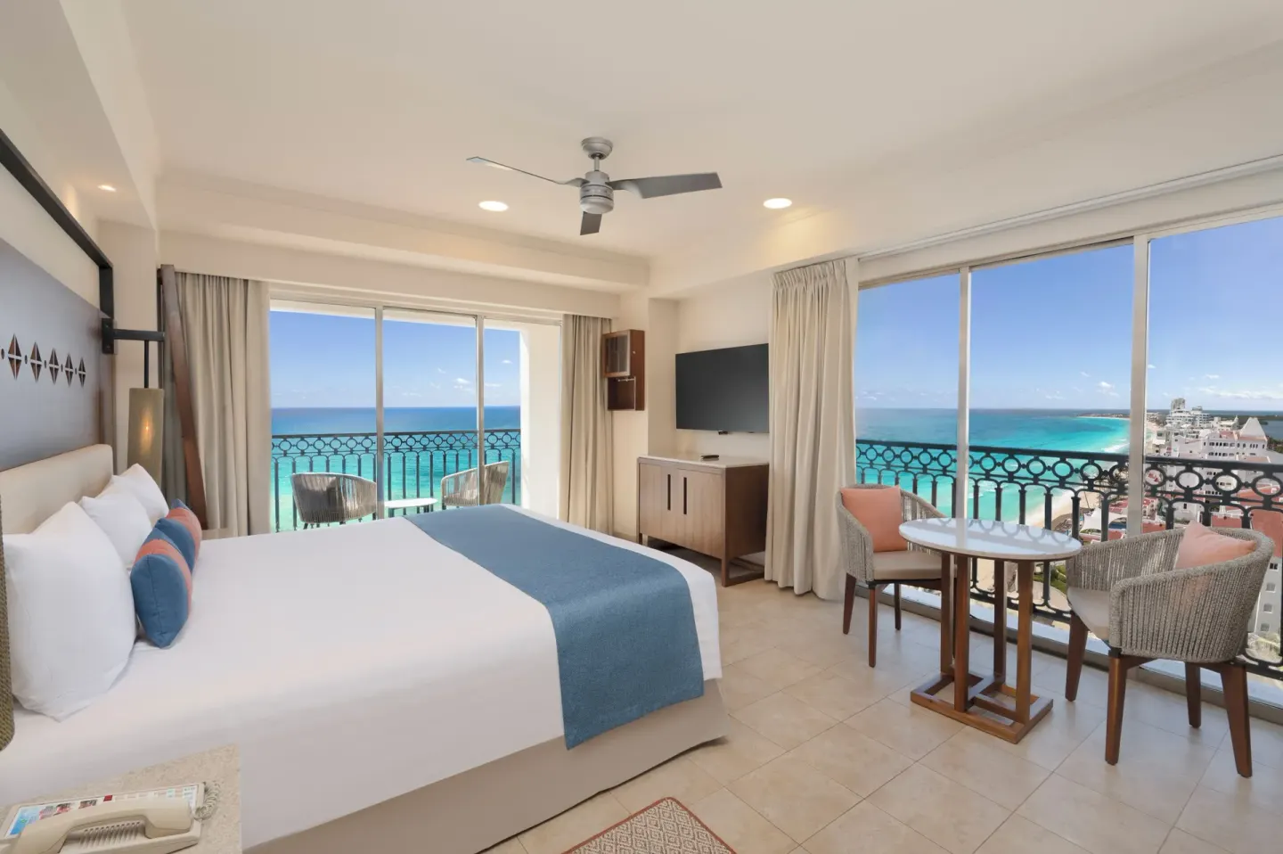 King bed guest room with ocean-facing windows at GR Solaris Cancun & Spa.