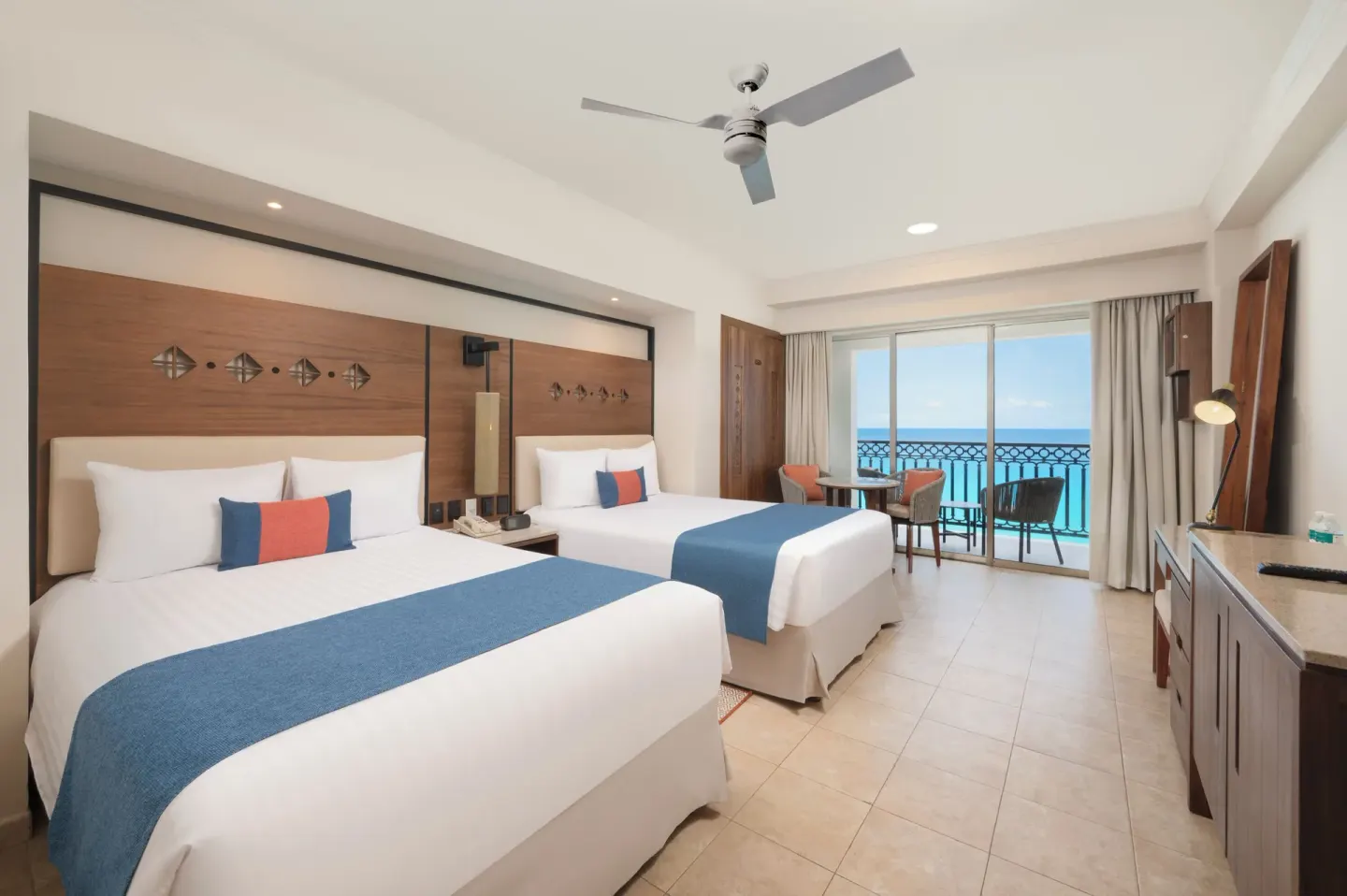 Two-bed ocean view room with desk and balcony at GR Solaris Cancun & Spa.
