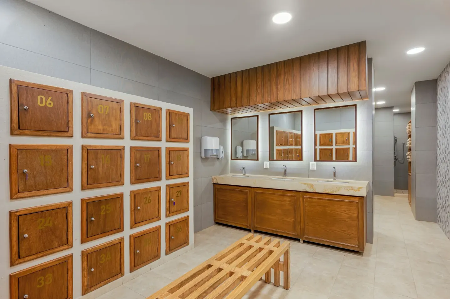 Spa locker room with wooden lockers and sinks at GR Solaris Cancun & Spa.